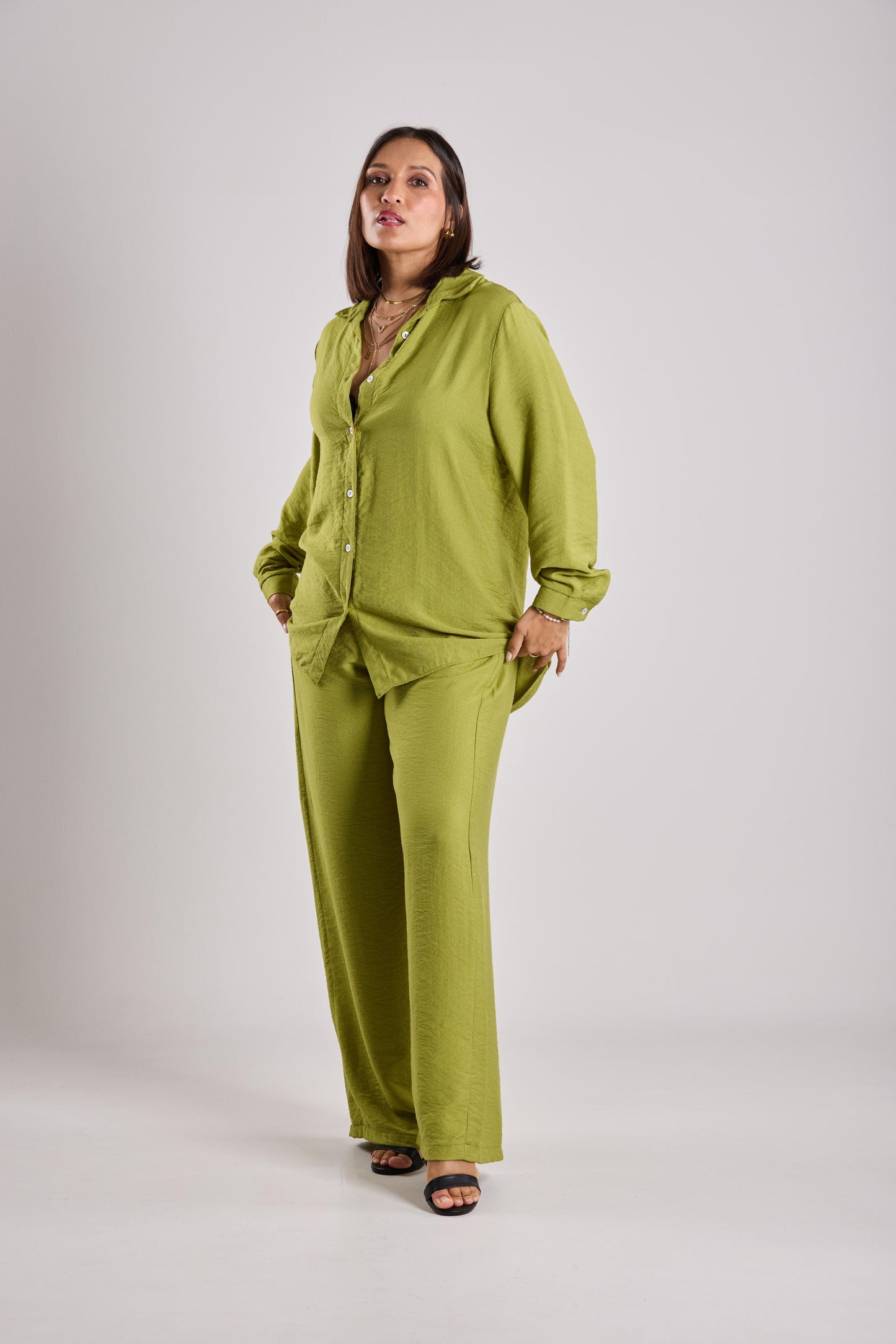 Woman wearing a two-piece outfit on a plain background